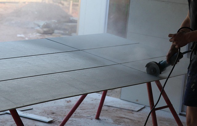 Aluminum roofing sheet being cut to size on a construction site