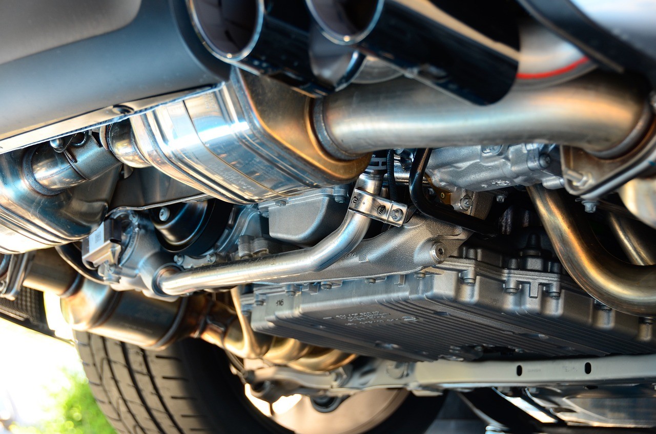Automotive exhaust system with muffler and heat shields where perforated aluminized silicon sheet is used