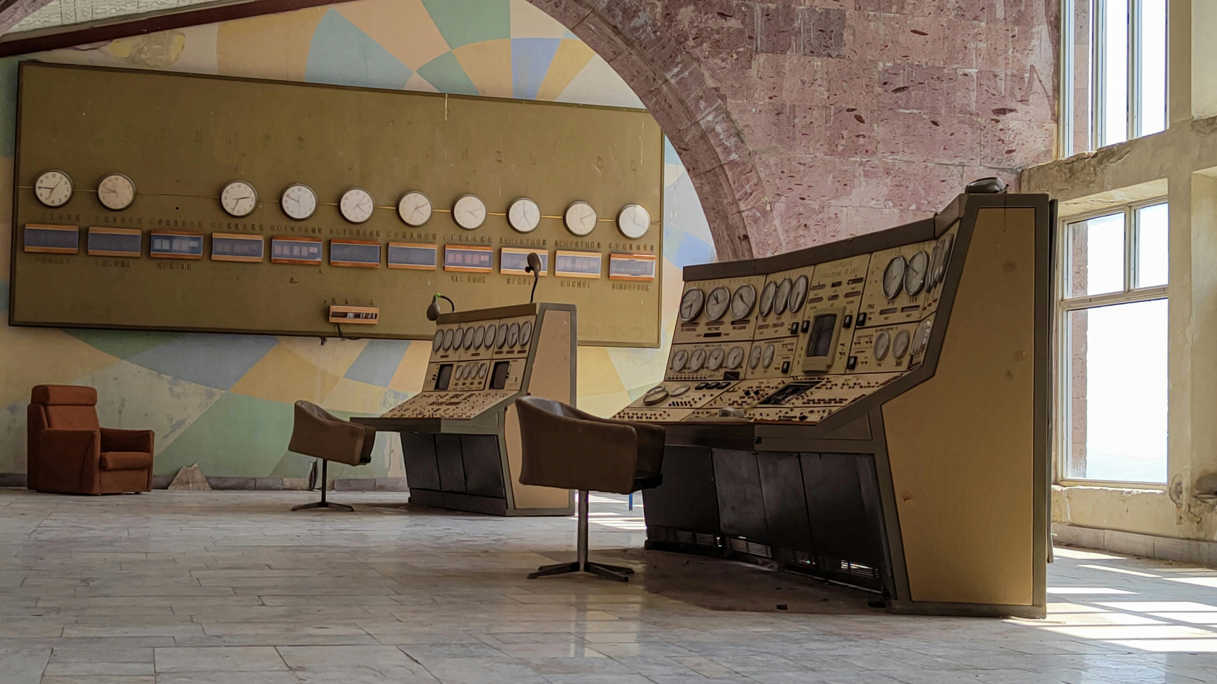 A traditional control room with multiple static screens showing complex data.