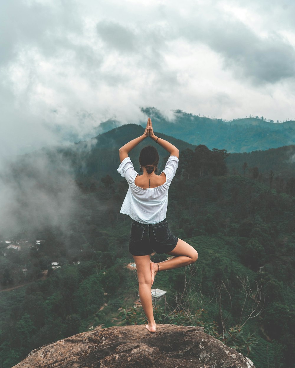 Person practicing yoga in a serene natural landscape, symbolizing inner calm and mental clarity