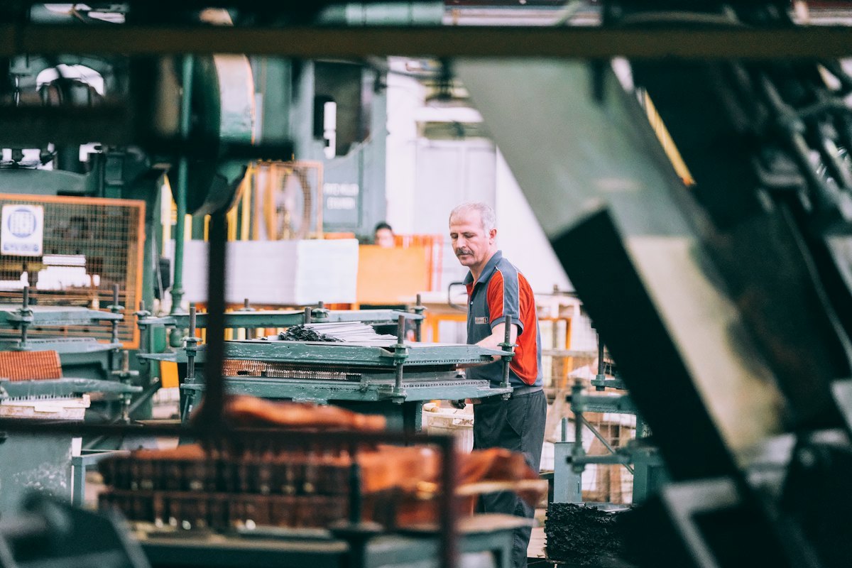Factory worker operating industrial production machinery