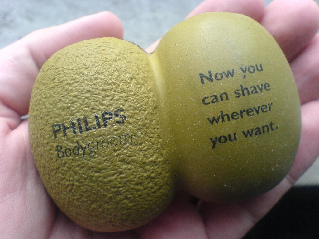 A hand squeezing a colorful stress ball