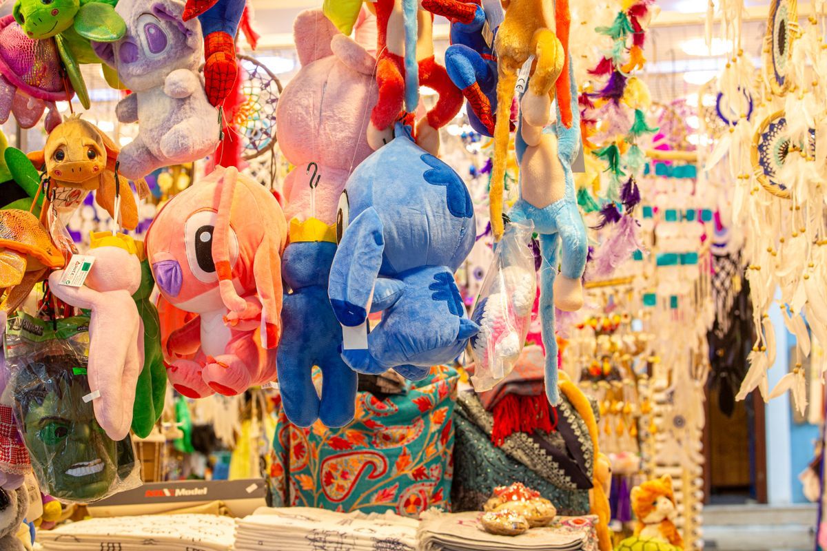 Colorful plush toys hanging in a market stall