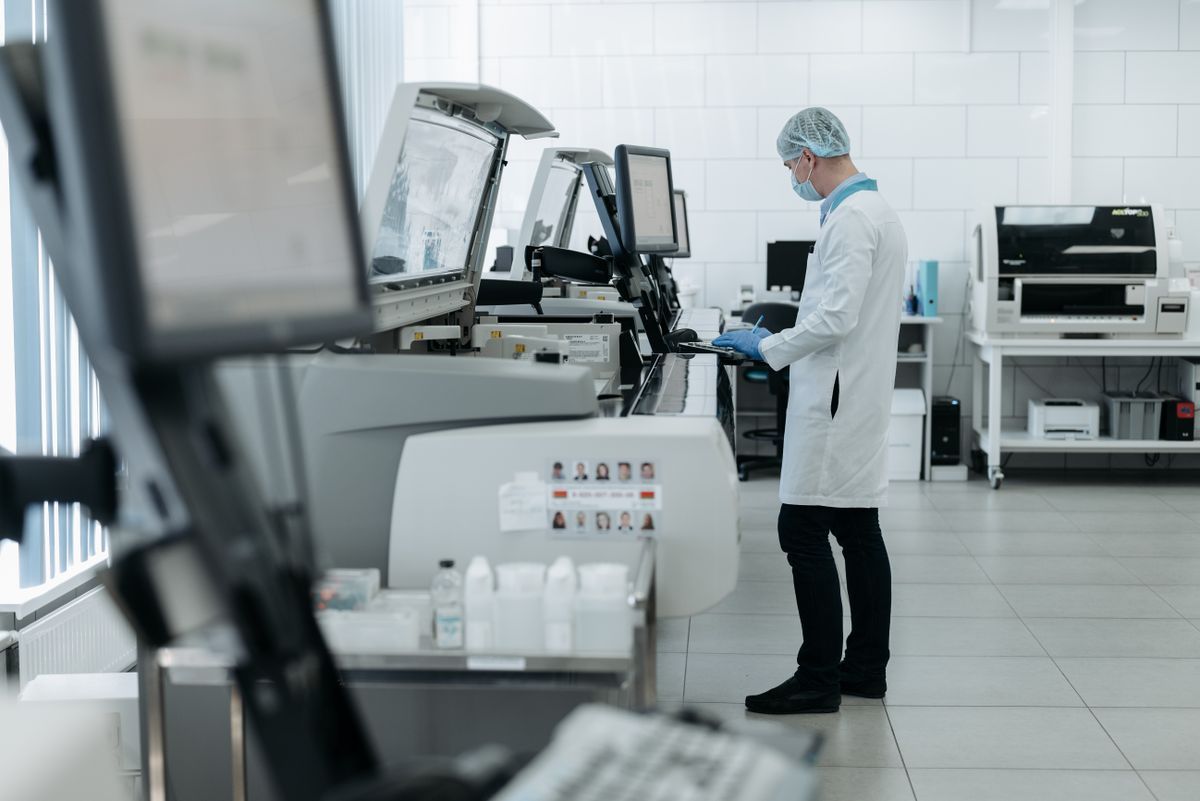 Lab technician operating analytical instruments in a testing laboratory