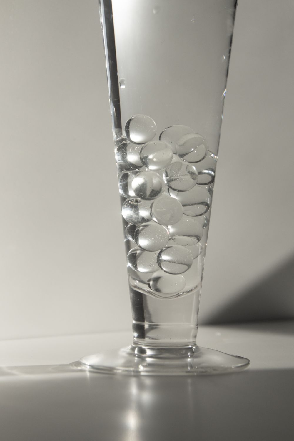 Transparent gel water beads swelling in a glass of water
