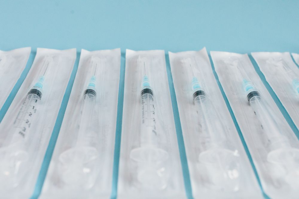 A row of individually packaged syringes with needles