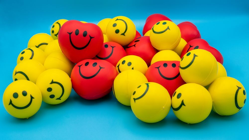 A pile of smiley-face squishy stress balls