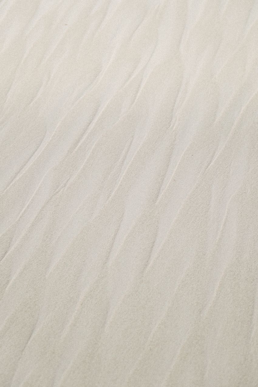 Close-up of fine sand showing its grainy texture