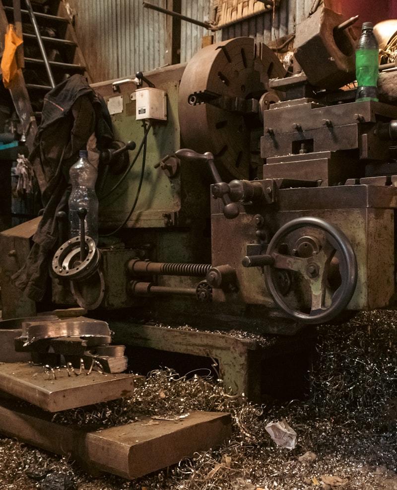 Metal lathe machine in workshop showing industrial manufacturing process