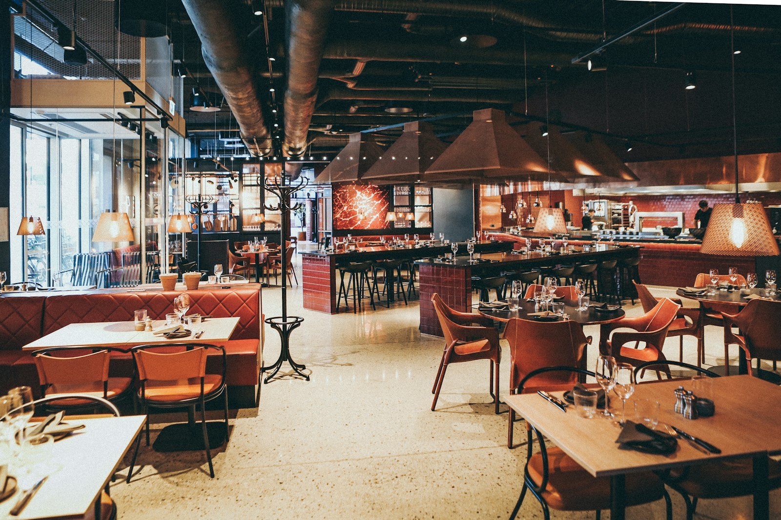 Restaurant interior with dark metal table bases and wooden tops