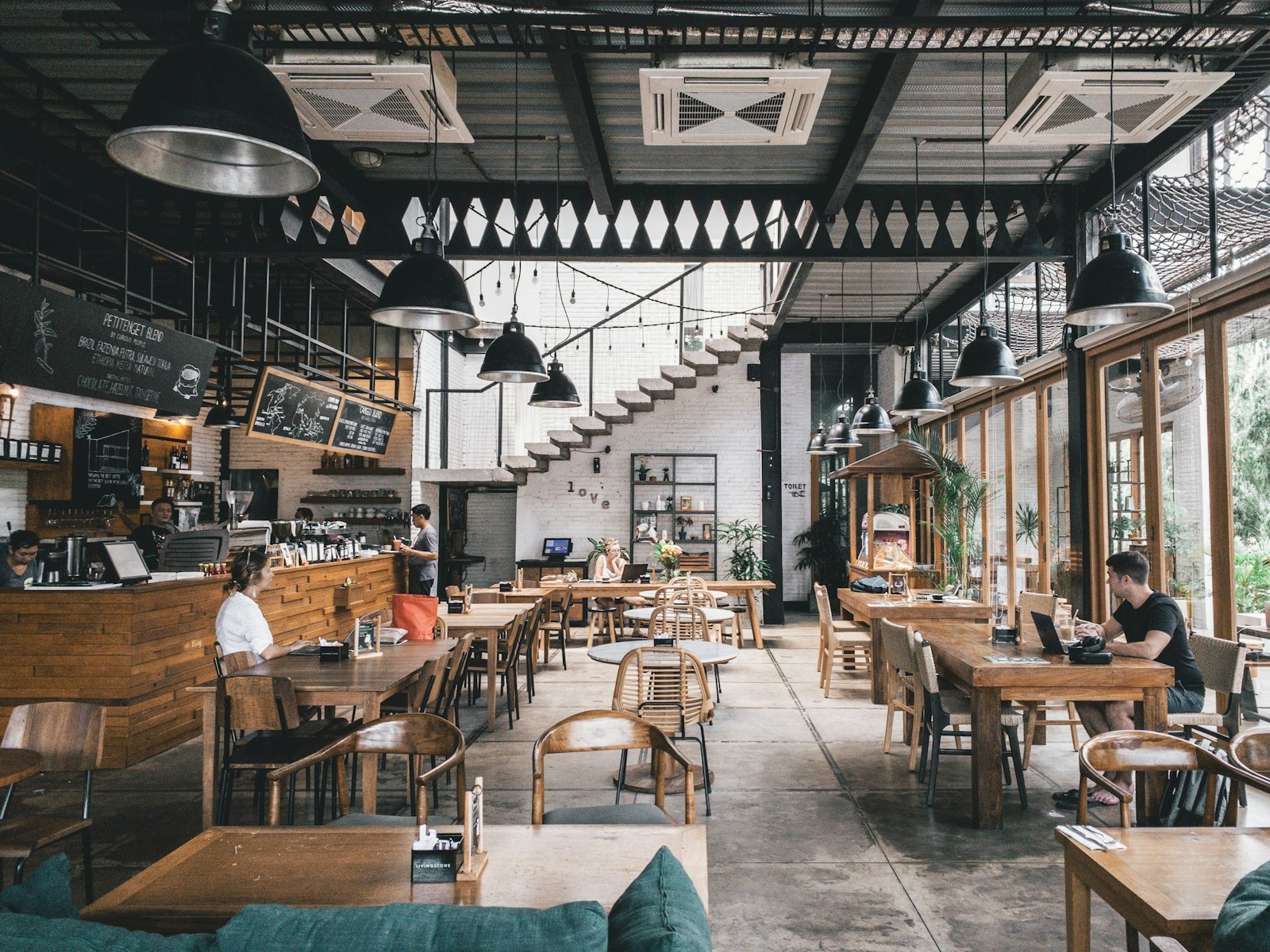 Cafe interior with wooden commercial tables