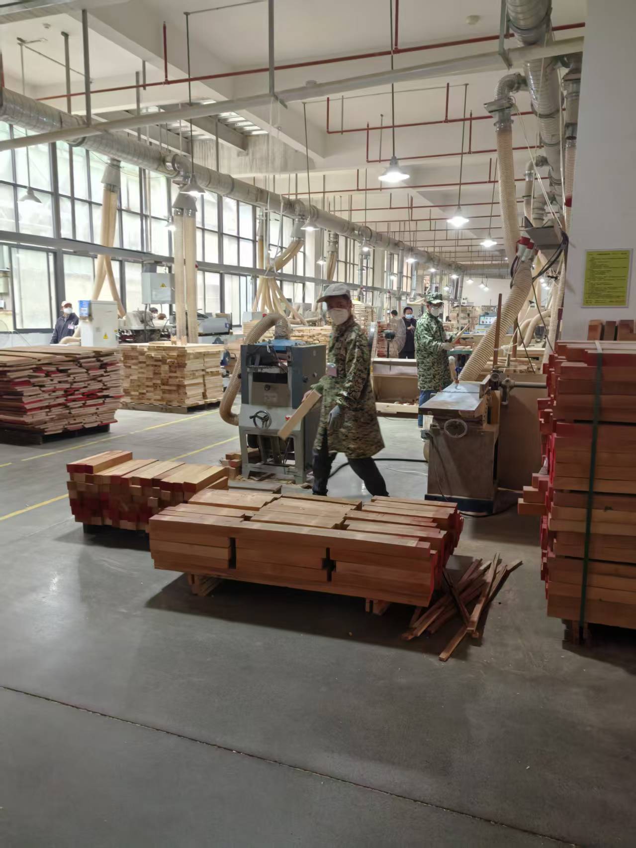 Packing finished wooden toys into boxes on packaging line