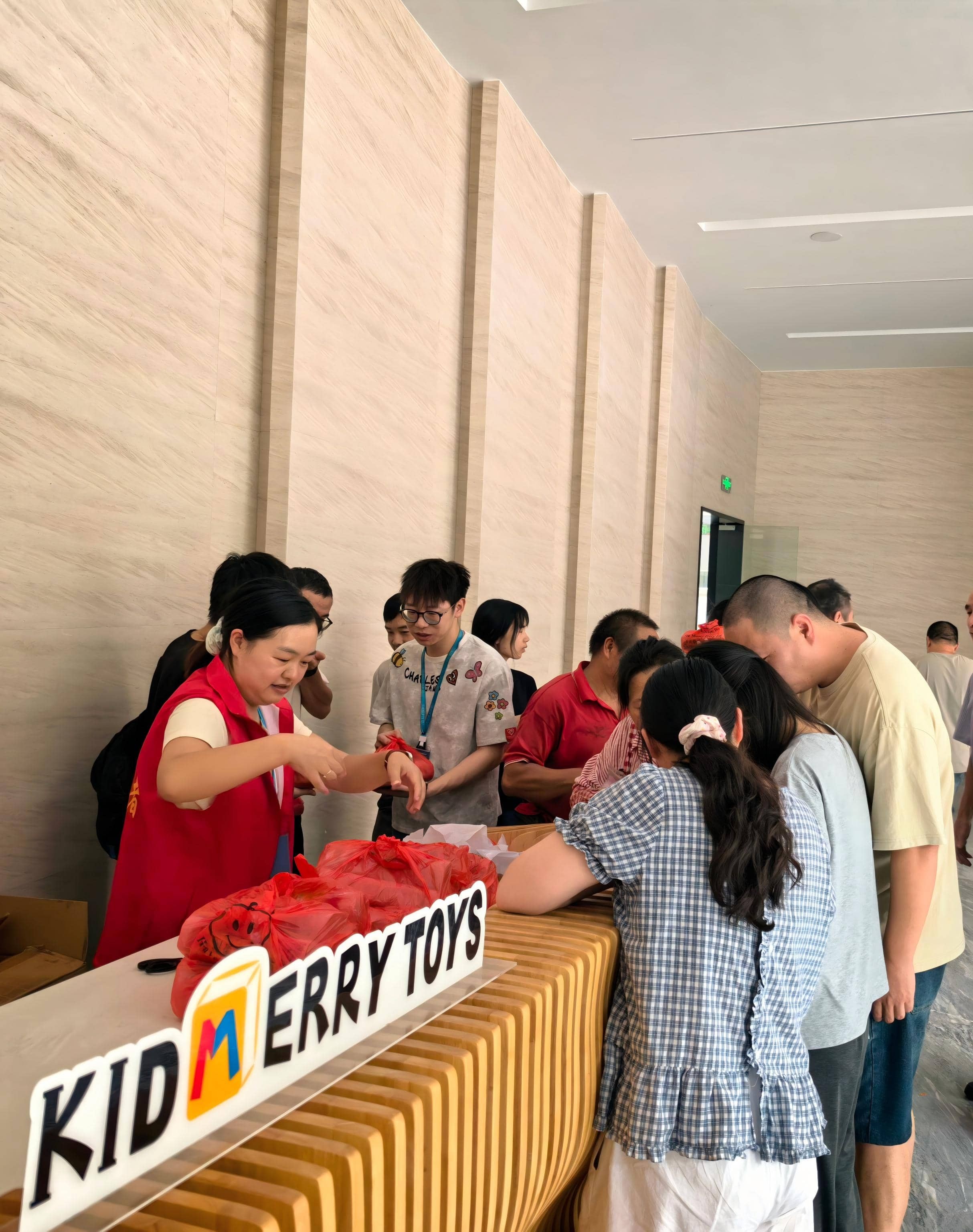 Employees collecting Mid-Autumn Festival gifts at the reception hall of KIDMERRY wooden toy factory