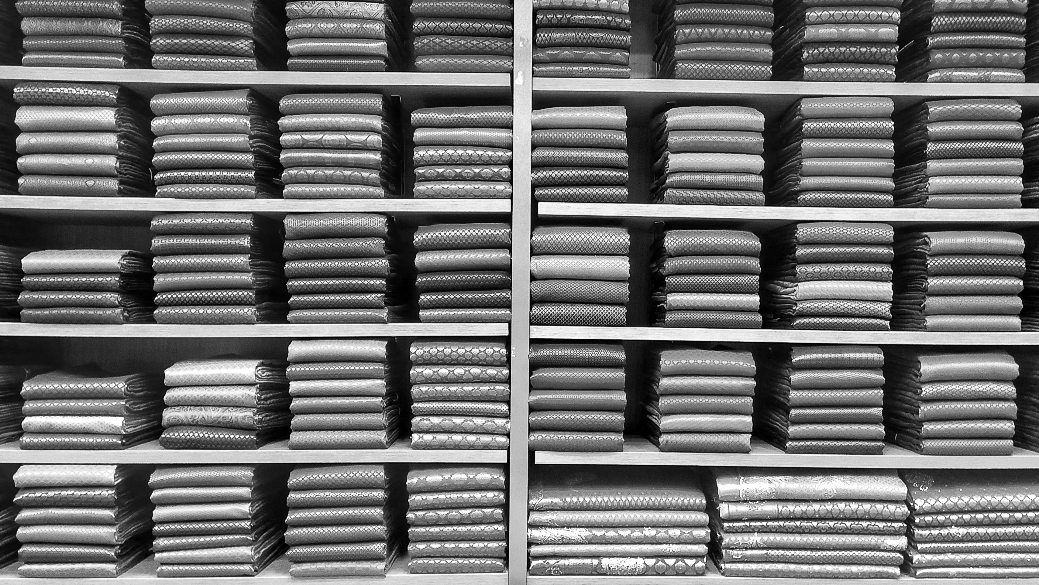 A warehouse showing neatly organized rows of yoga wear ready for shipment, indicating scalable production