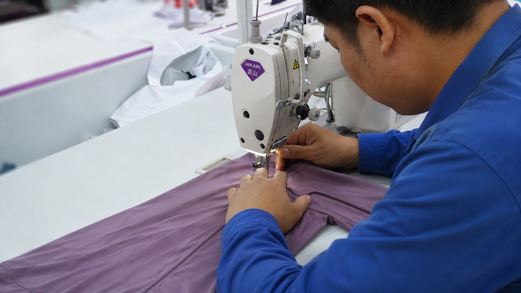 Easemotion yoga wear factory worker sewing sustainable purple fabric with industrial HIKARI sewing machine