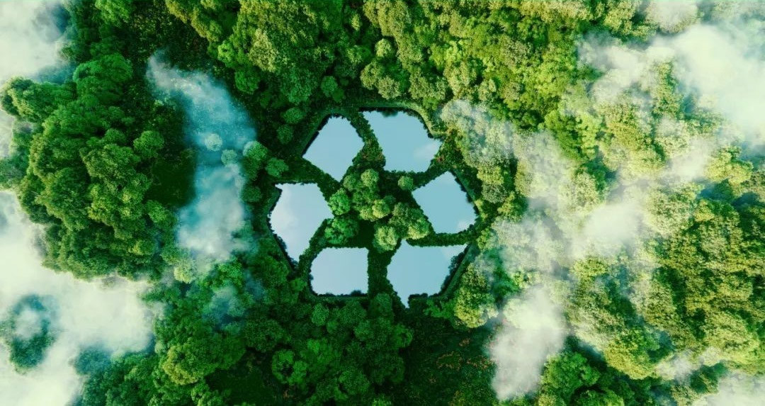 Aerial recycling symbol water ponds in green forest, circular economy & ISO14001 sustainable environmental management 
