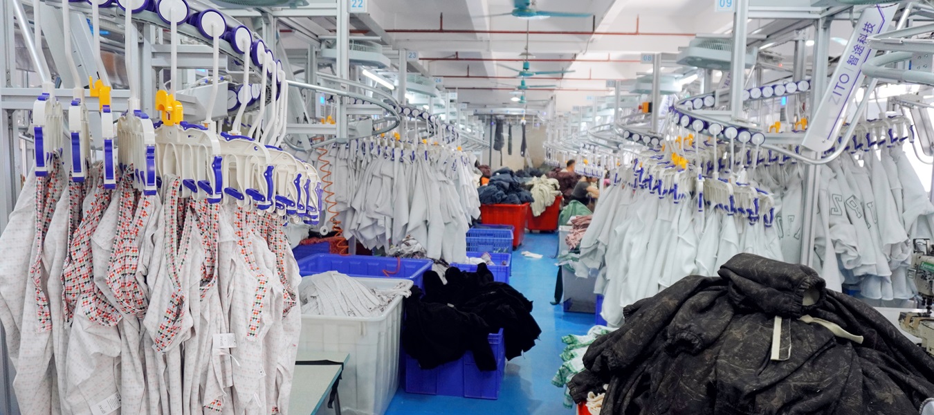 Overhead garment conveyor system in the Easemotion production workshop.