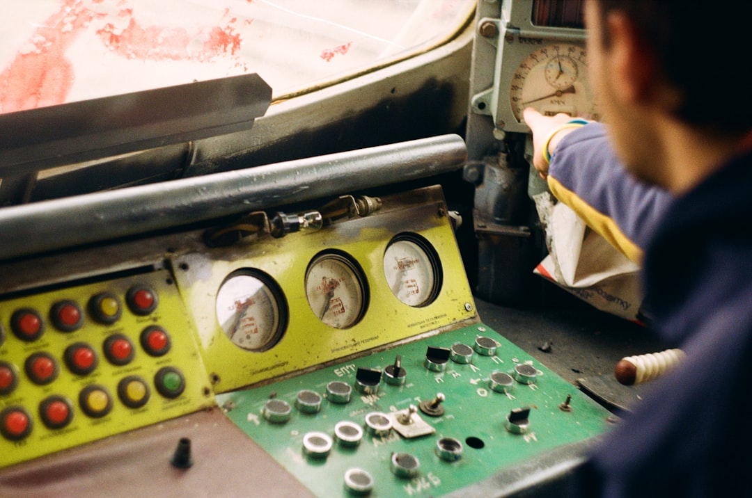 Technician checking gauges on a diesel generator control panel