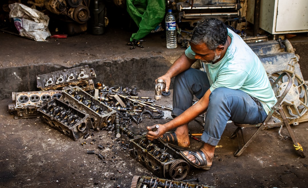 Technician inspecting a high-efficiency diesel engine component