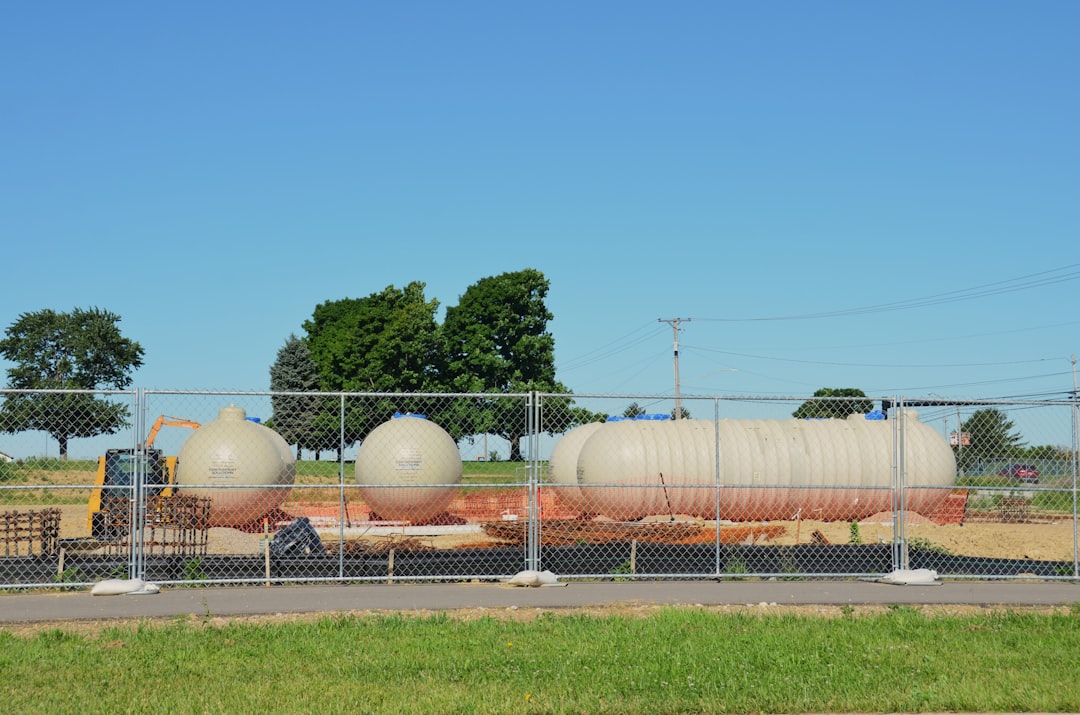 A portable gasoline generator next to a propane tank to illustrate fuel options for a construction site generator