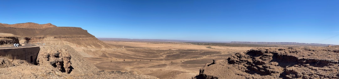 A panoramic view of a vast, open-pit mine, illustrating its remote location and scale