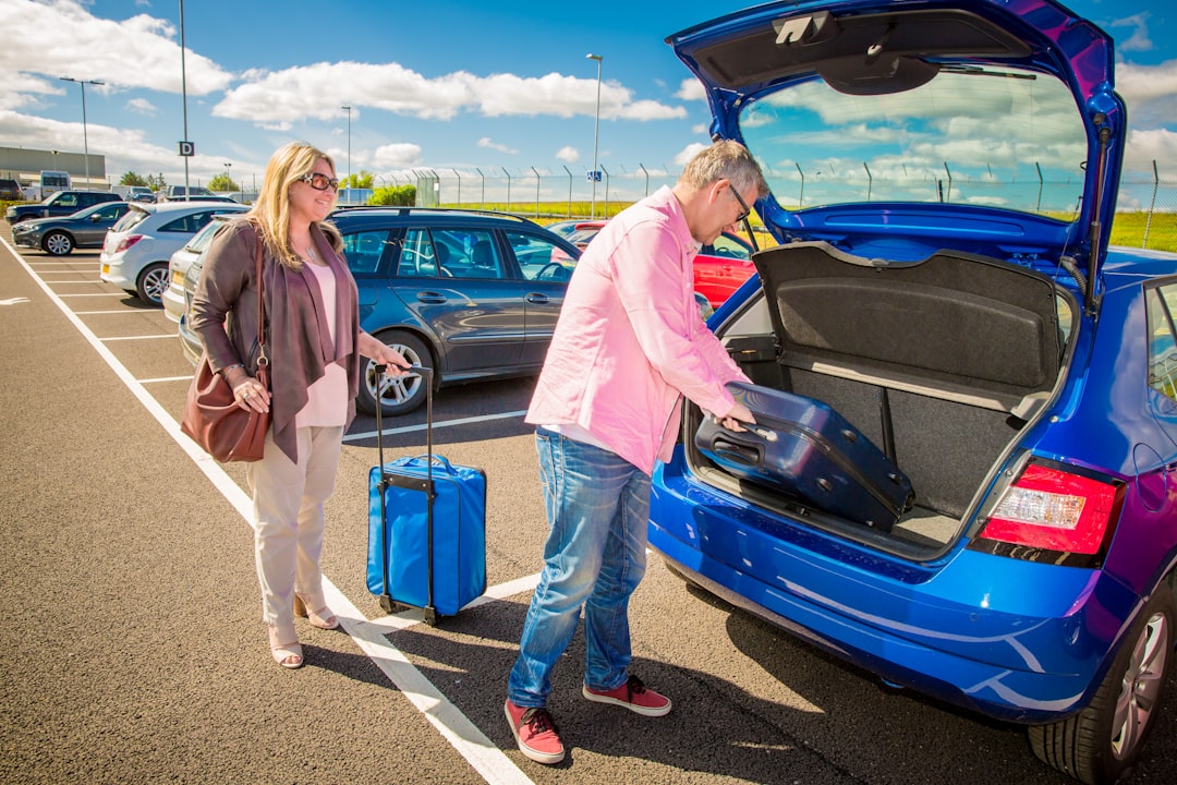 A person easily loading a compact inverter generator into a car trunk