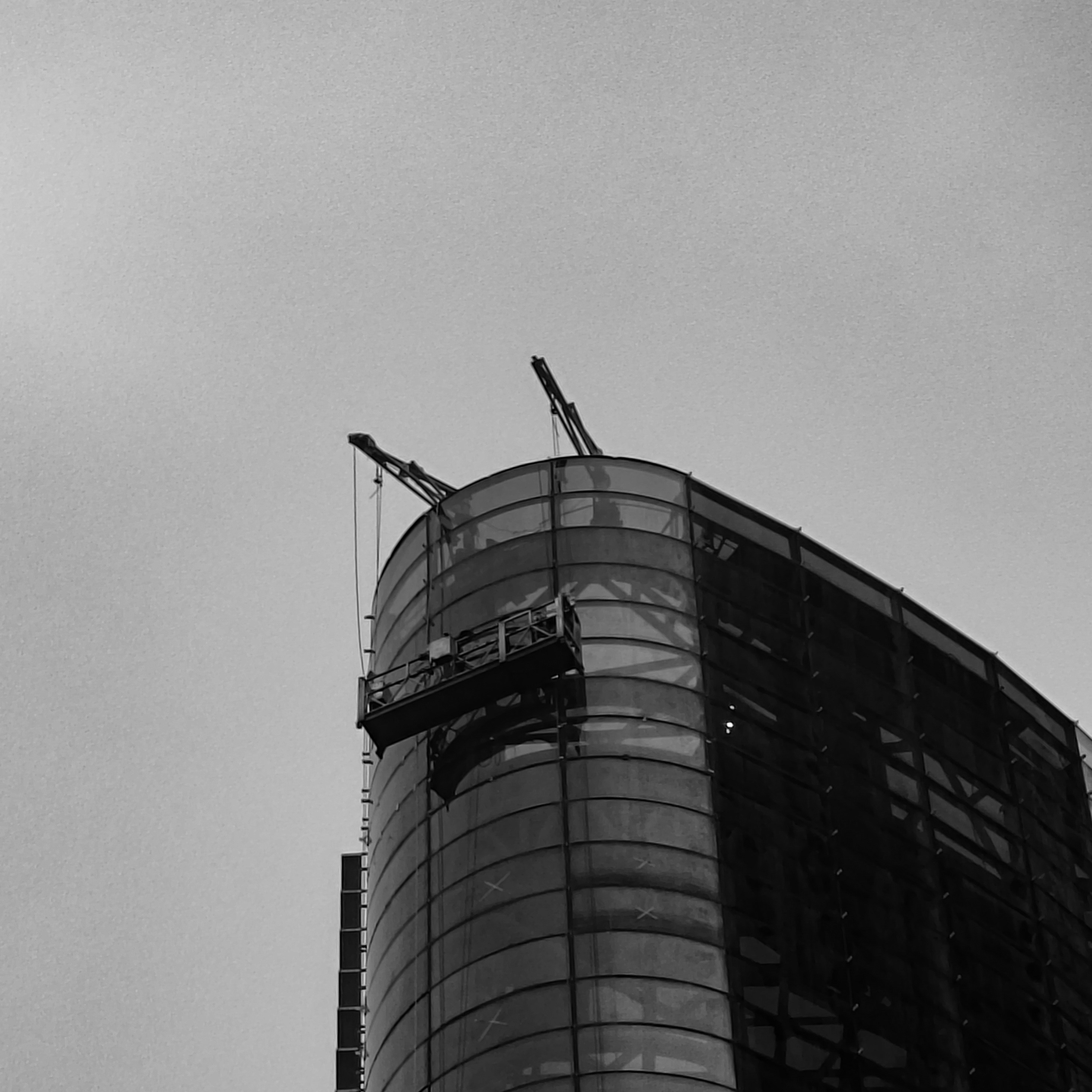 Architectural drawing of a curtain wall system being installed on a modern skyscraper.