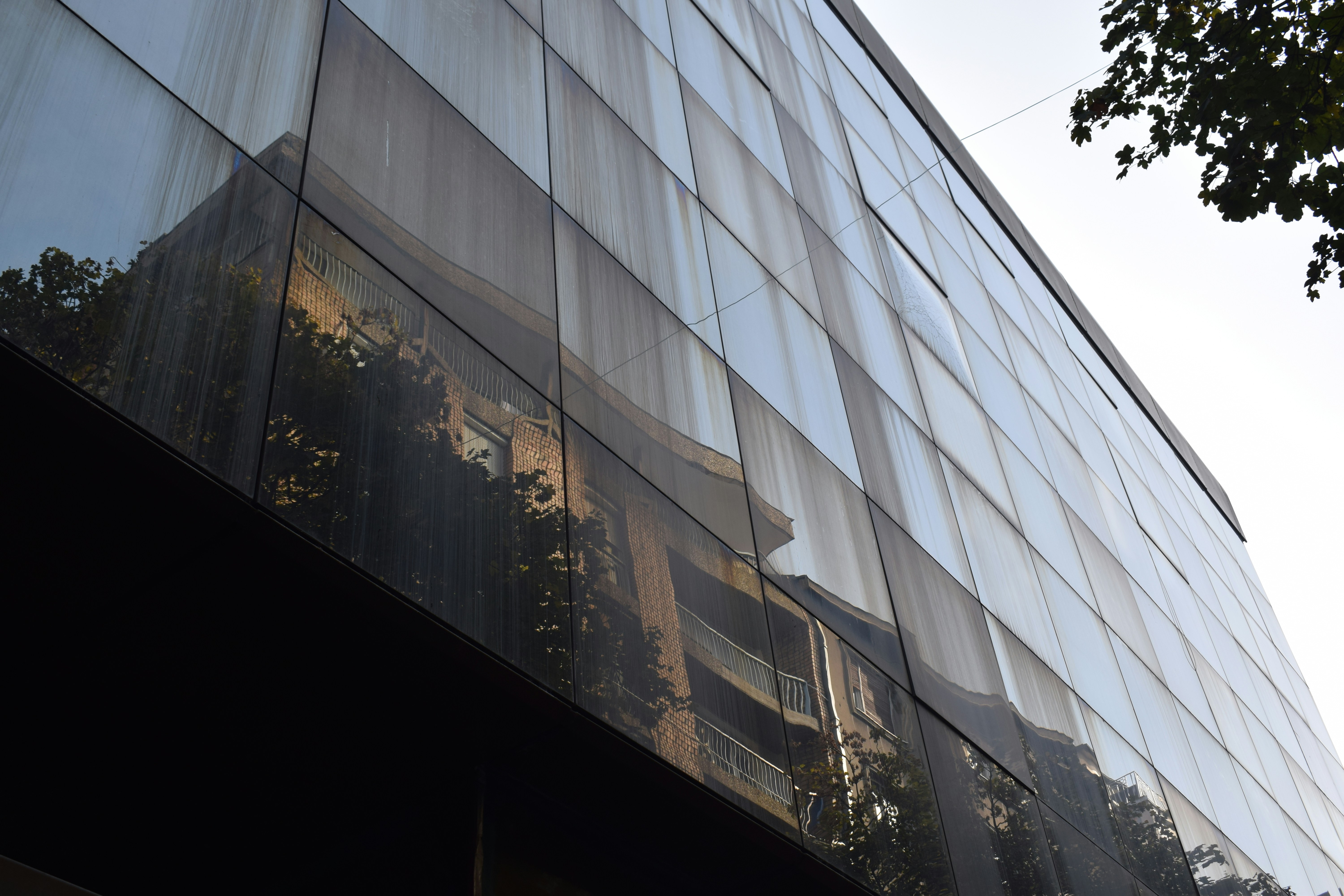 Close-up shot of a curtain wall system that integrates Building Integrated Photovoltaics (BIPV) into the glass panels.