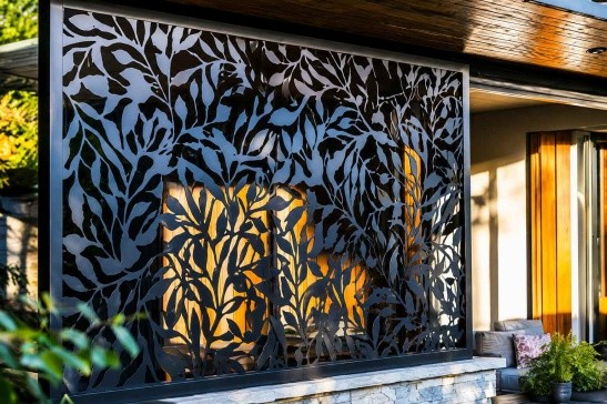 Custom laser cut metal screen with leaf pattern for outdoor patio