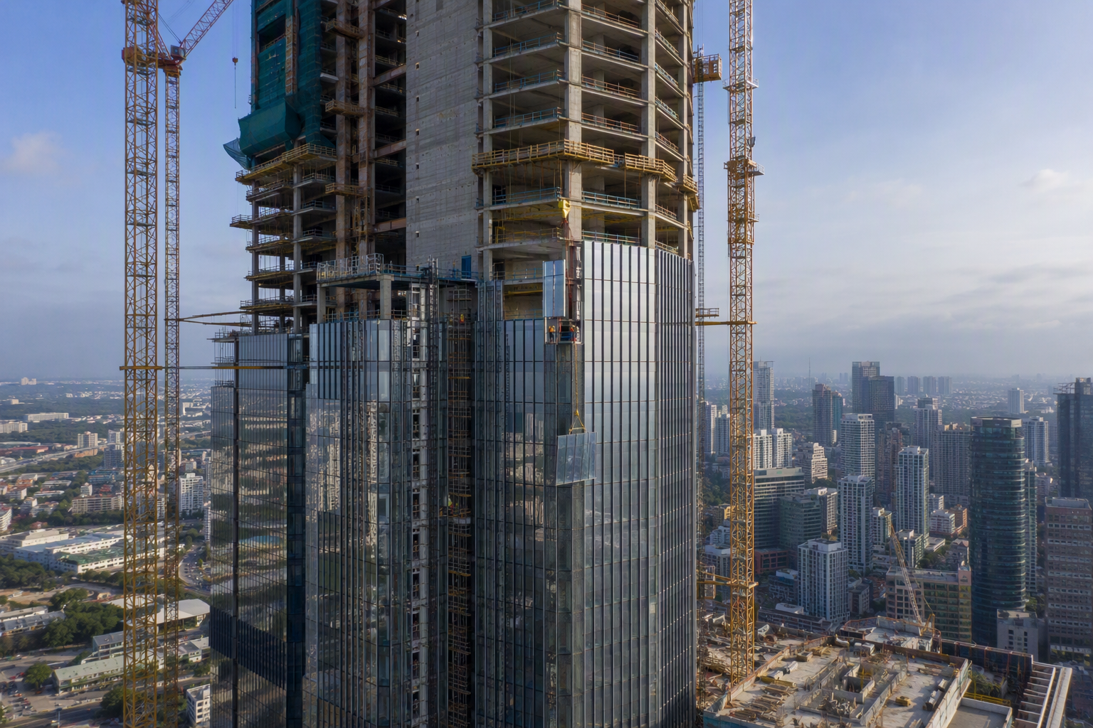 Mega-scale skyscraper construction site with unitized curtain wall installation