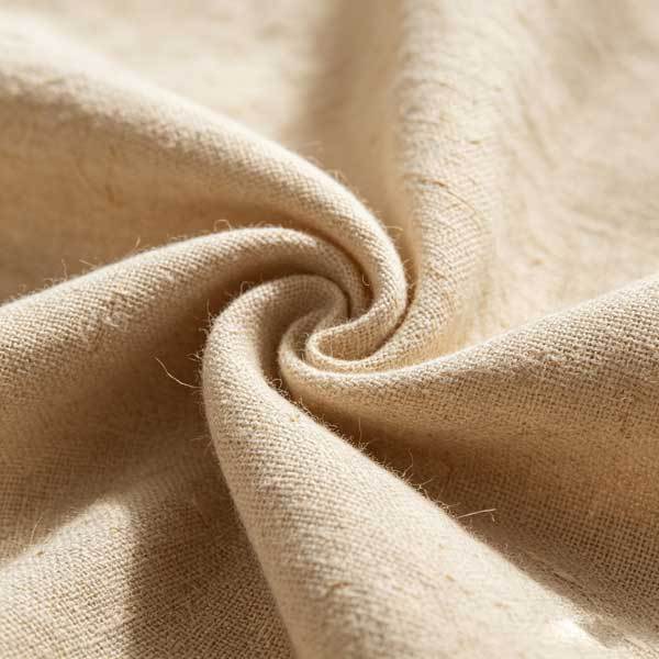 Close-up photo of premium European flax linen fabric showing natural slubs, texture, and weave details, soft natural lighting, macro textile photography, neutral warm tones