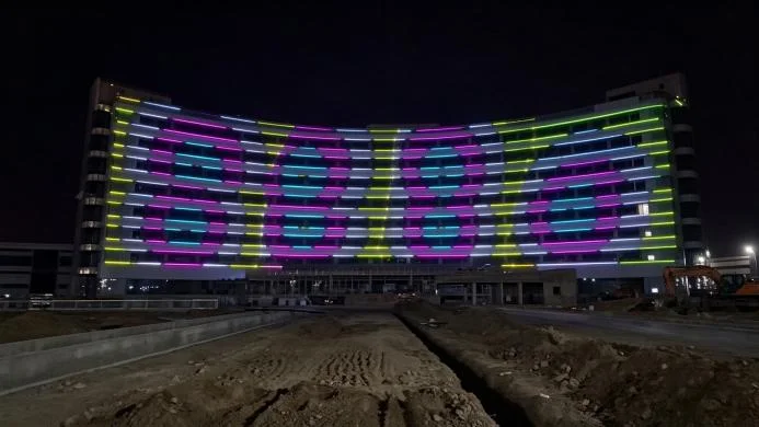 outdoor waterproof laser lights outlining a group headquarters tower at night in Xinjiang