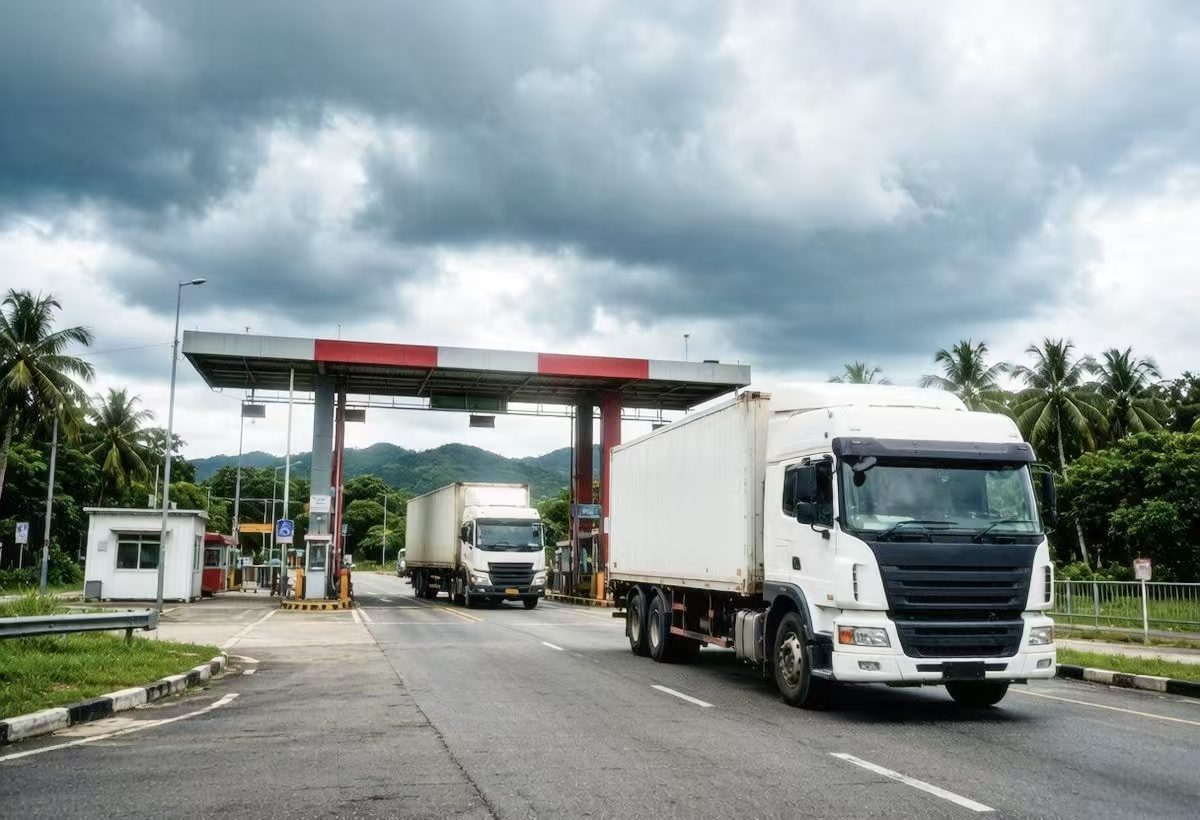 Trucks crossing a border checkpoint in Southeast Asia