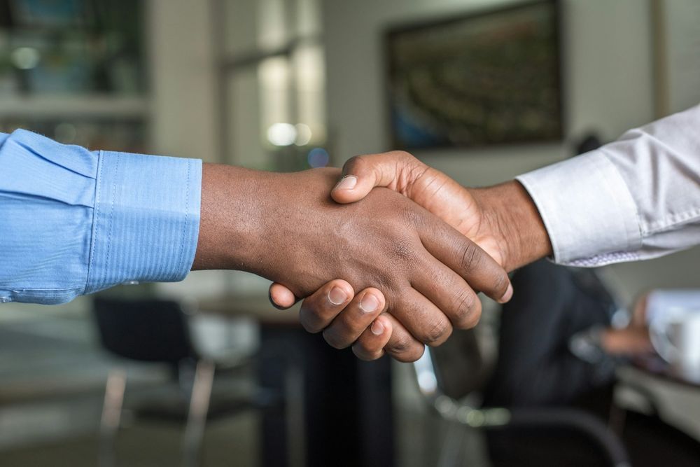 Two business partners shaking hands to confirm a long-term supply chain partnership