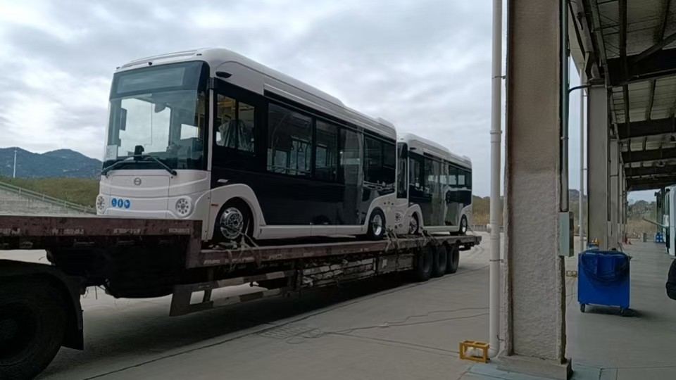 The bus is being prepared for transport on a trailer.