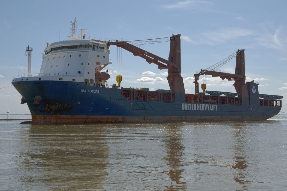 Heavy-lift project cargo vessel with its own deck cranes at berth