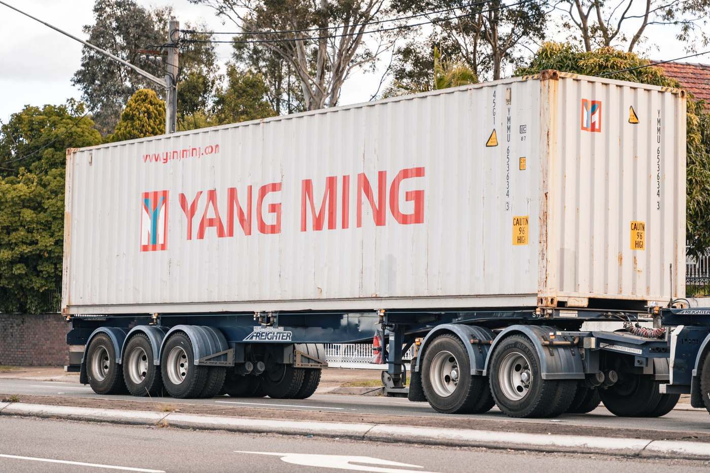 A shipping container carried on a road freight truck