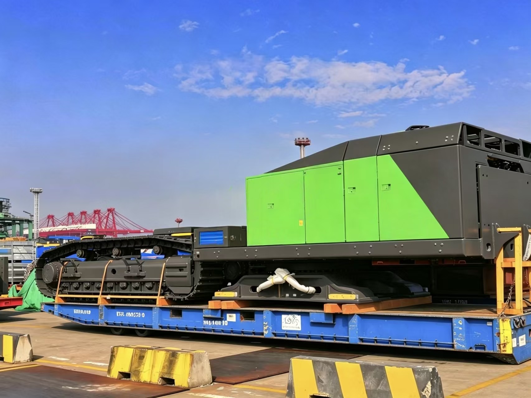 Port staff supervising lifting of heavy equipment onto breakbulk ship