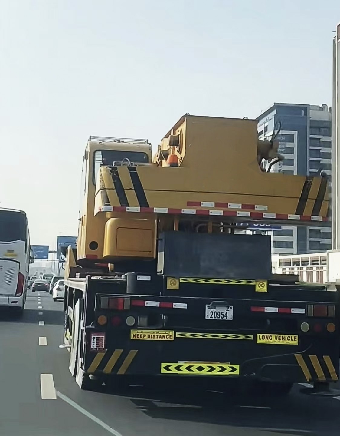 Construction machinery transported by heavy trailer on a highway in Dubai