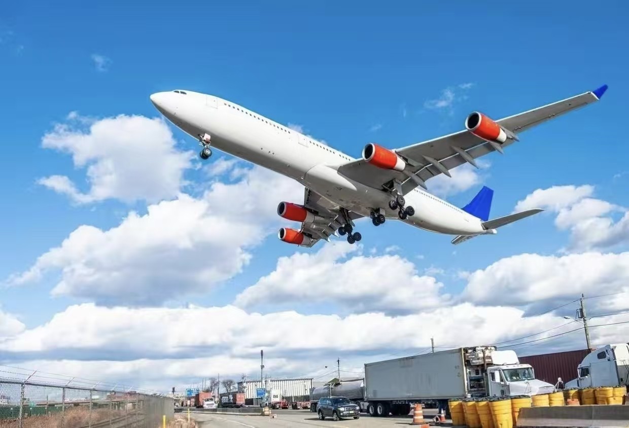 Cargo pallets being loaded into a freighter aircraft on the airport apron