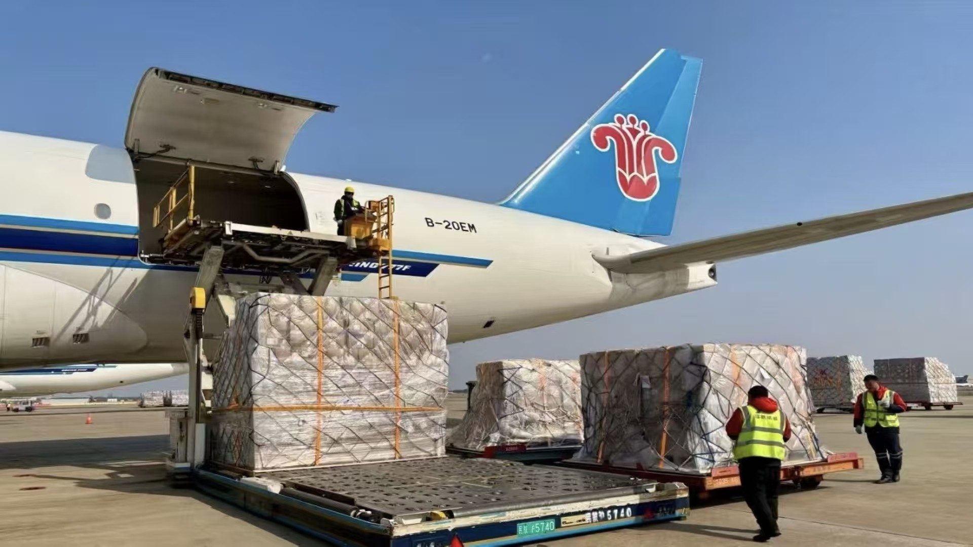 Palletised air cargo on dollies at an air cargo terminal