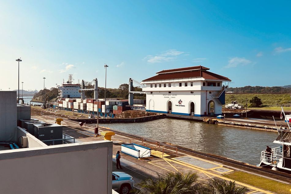 Panama Canal Miraflores locks with a vessel under a clear blue sky