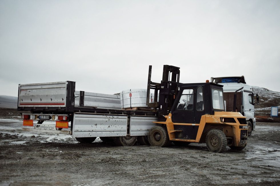 Forklift loading palletised cargo into the trailer of a freight truck