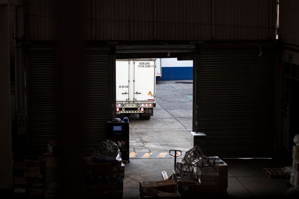 Delivery truck leaving the loading dock of a distribution warehouse