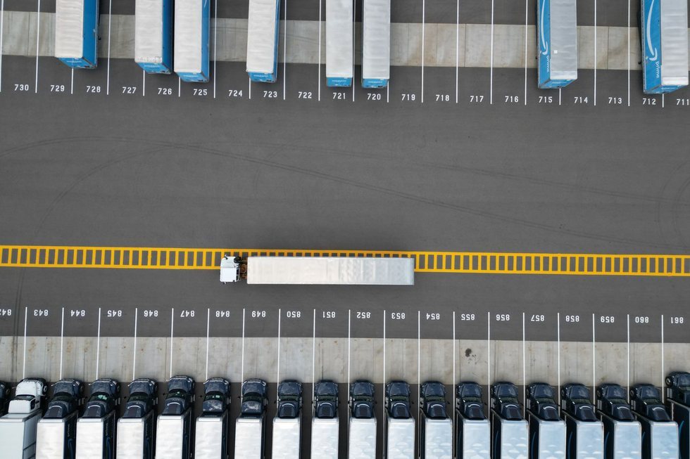 Aerial view of a logistics yard with rows of parked truck trailers