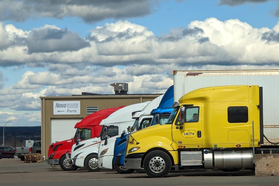 Freight trucks parked outside a logistics warehouse at a distribution hub