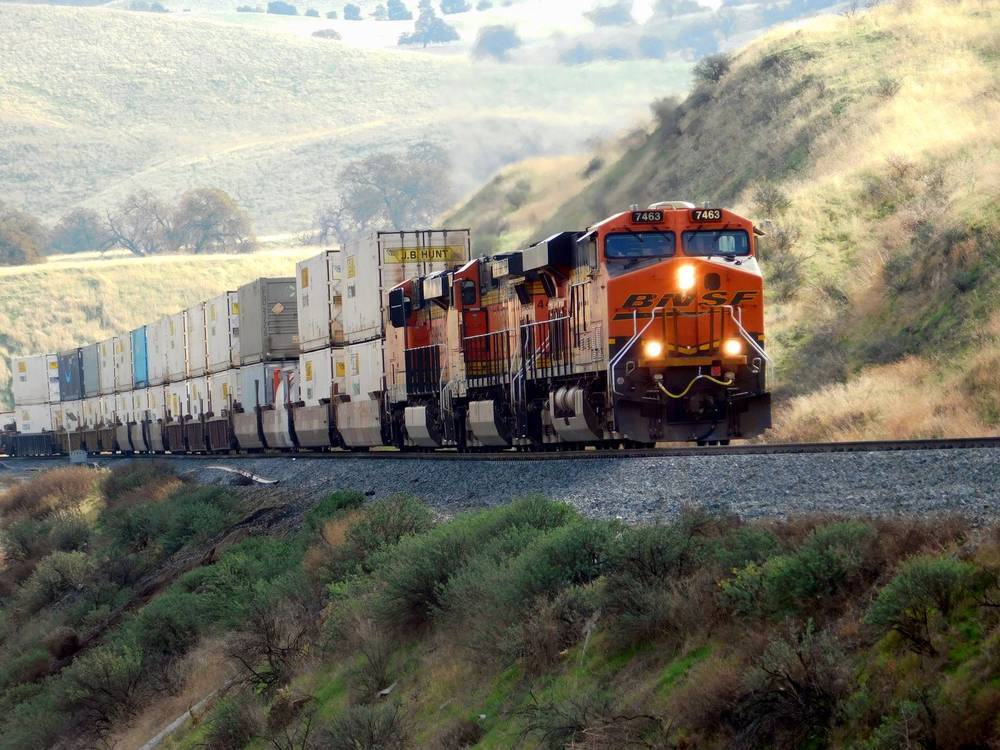 Freight train running through open countryside on a fixed block-train schedule