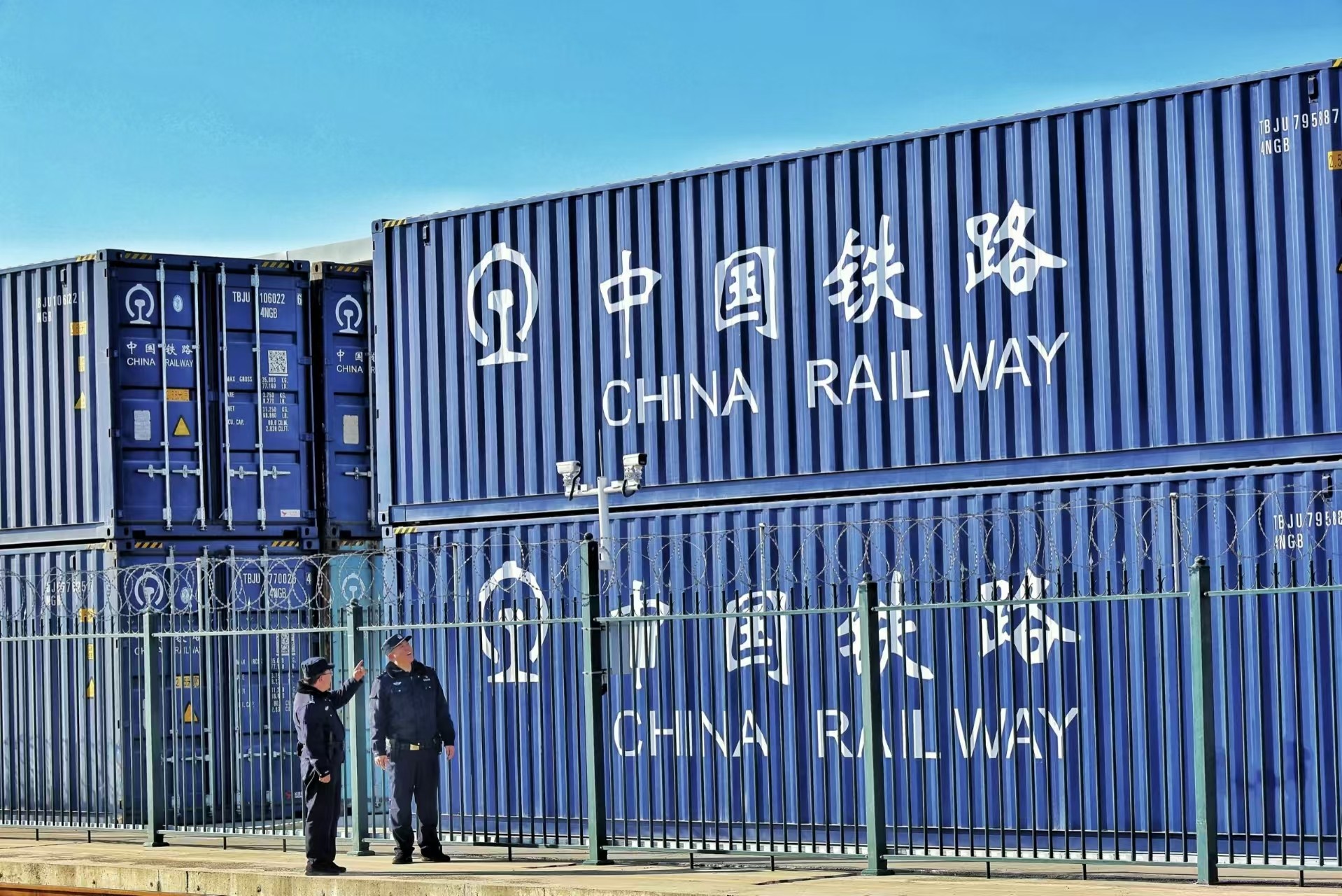 Block train carrying colourful shipping containers on the main line