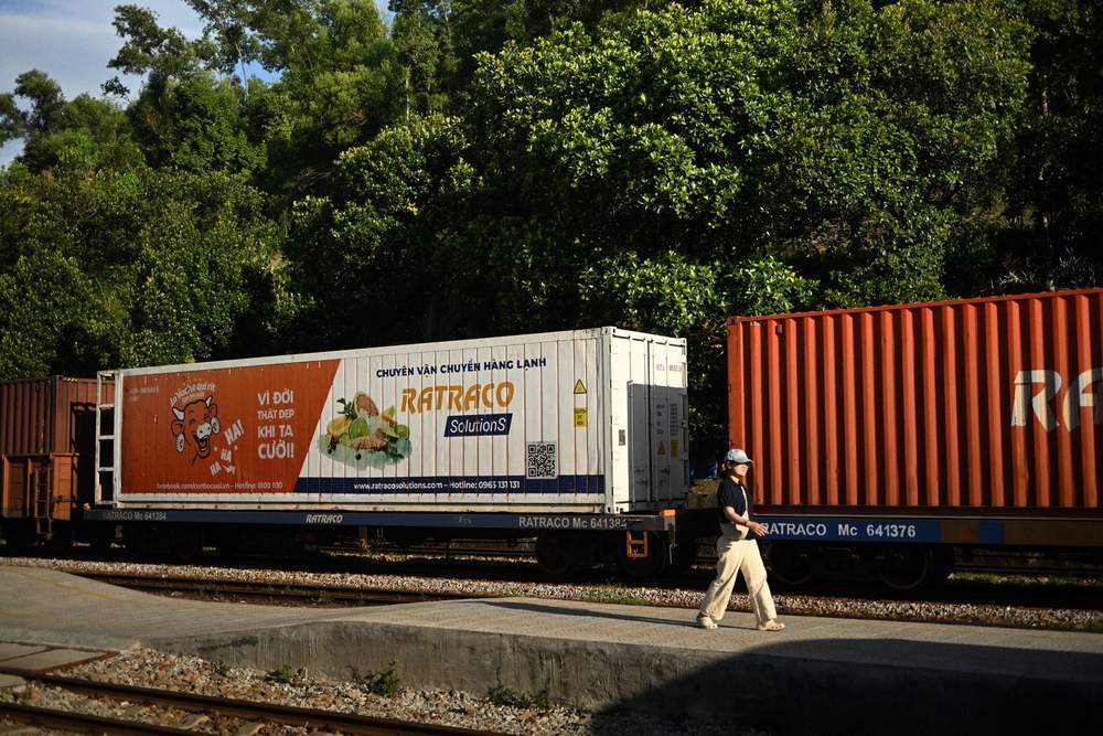 Oversized construction machine on a flatbed trailer that cannot fit rail loading gauges