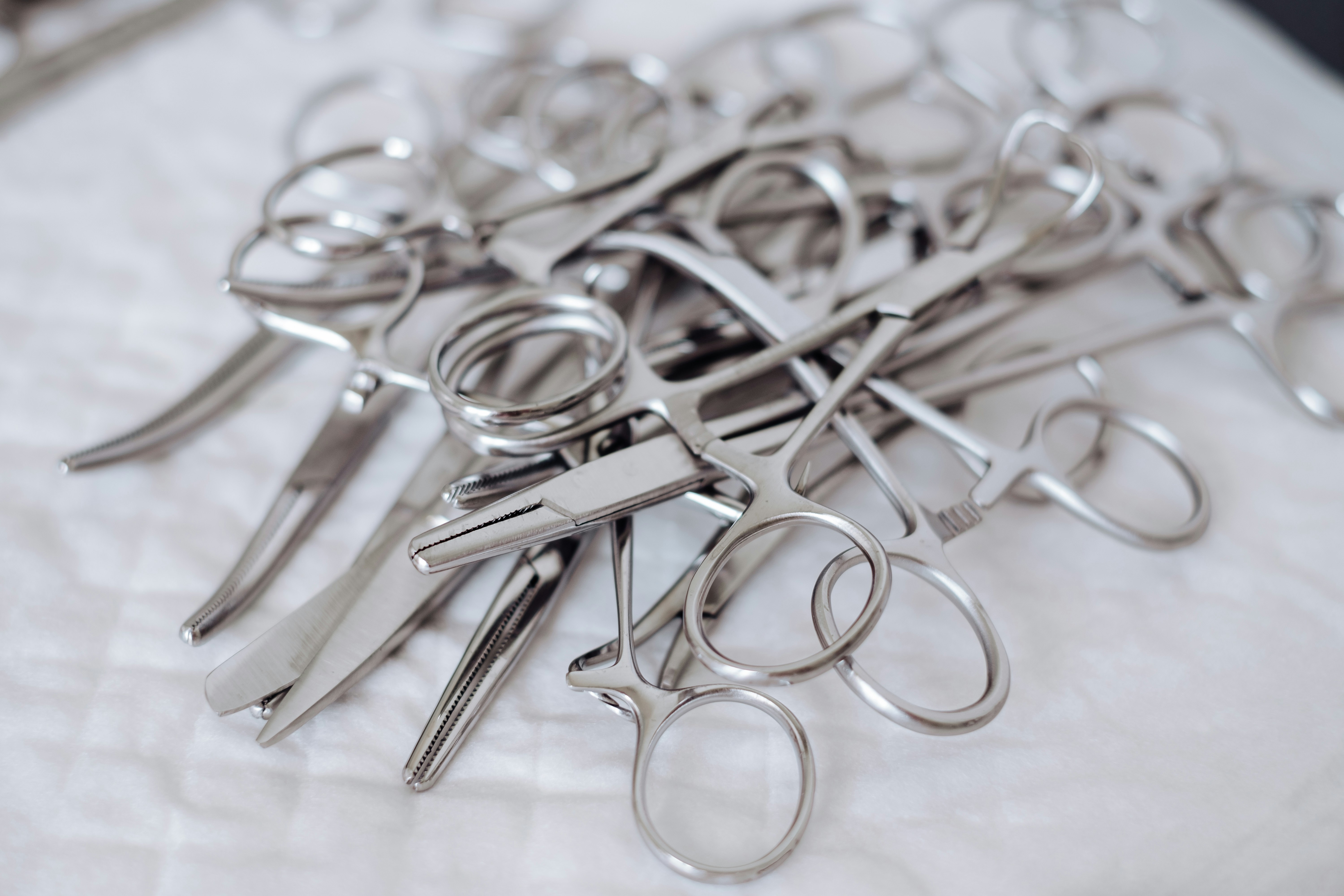 A series of shiny CNC-machined stainless steel medical instruments